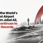 BD logo in top-left with a bold headline about UAE infrastructure and Dubai’s skyline on the right (grayscale) with a red arc, banner-style image.